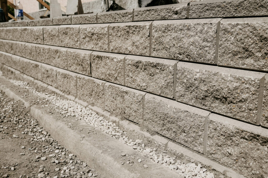 Close-up of an Earth and Turf Landscaping Edmonton retaining wall.