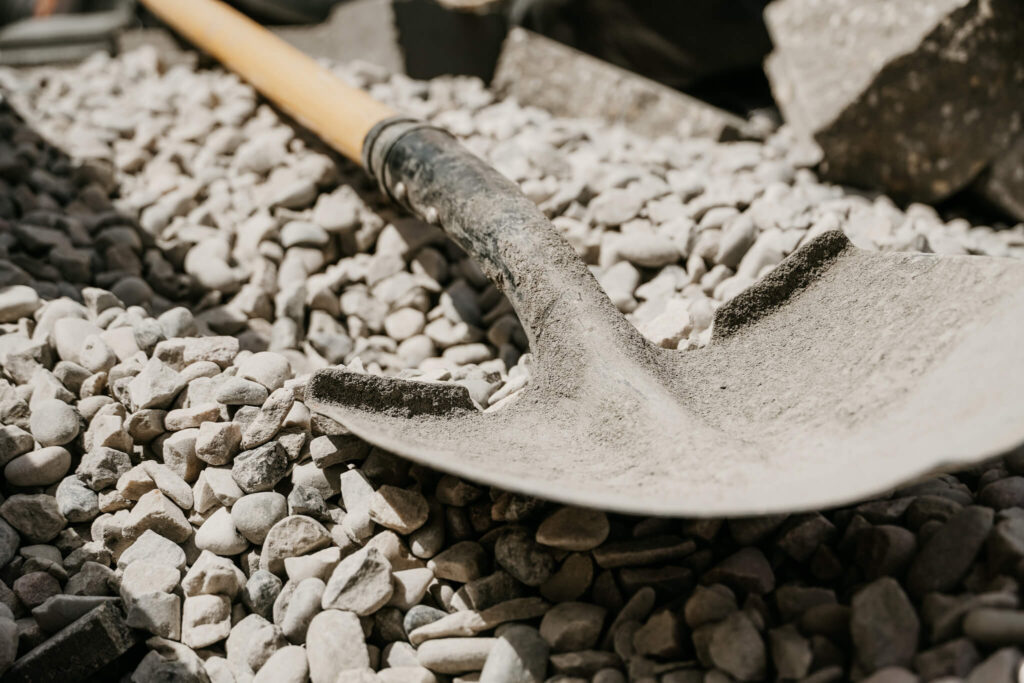 Close-up of a shovel sitting in some gravel on an Earth and Turf Landscaping Edmonton retaining wall job site.