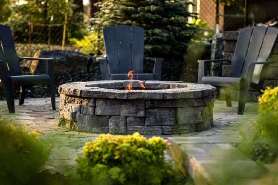 Backyard stone campfire with chairs.