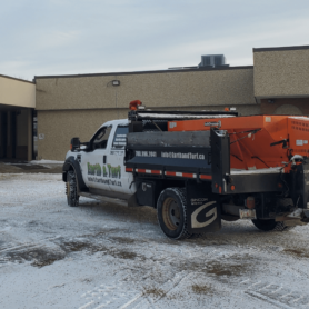 Earth and Turf Sanding Truck parked in a recently cleared parking lot