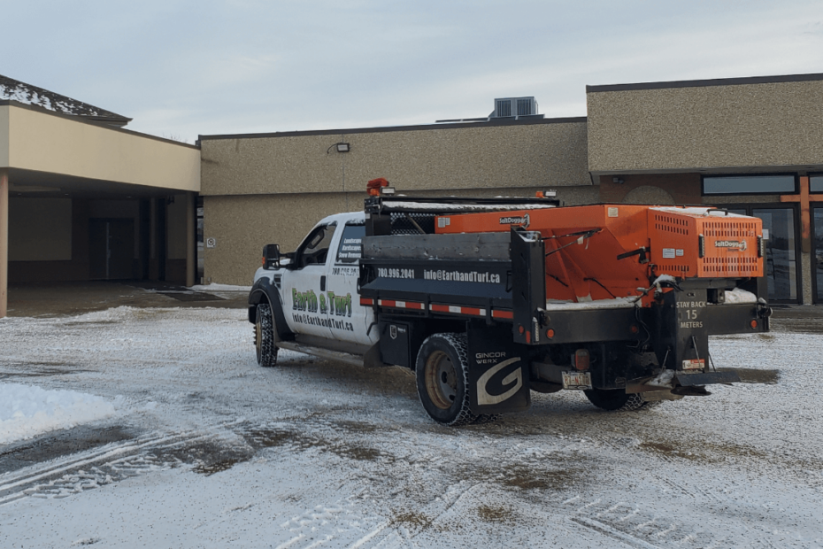 Earth and Turf Sanding Truck parked in a recently cleared parking lot